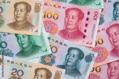 Chairman Mao (Mao Zedong) portrait on 100, 50, 20, 10 Chinese paper currency Yuan renminbi banknotes background. China or economy of Asia growth, financial business, US trade war concept photo