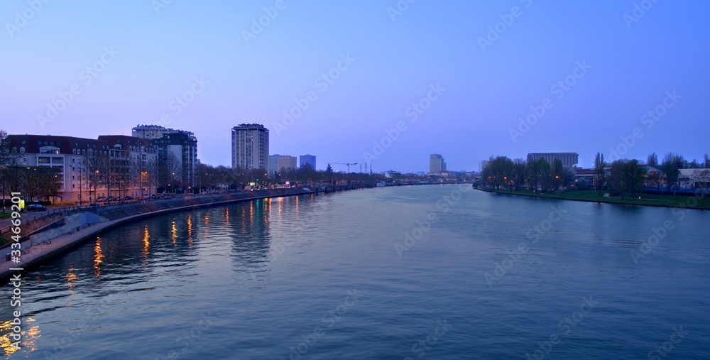 The Seine River and buildings in Alfrotville at sunset in Paris, France