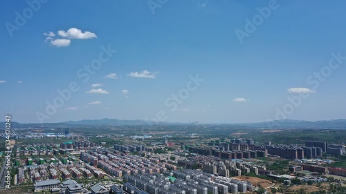 Aerial photography of Chinese urban residential areas under beautiful blue sky and white clouds