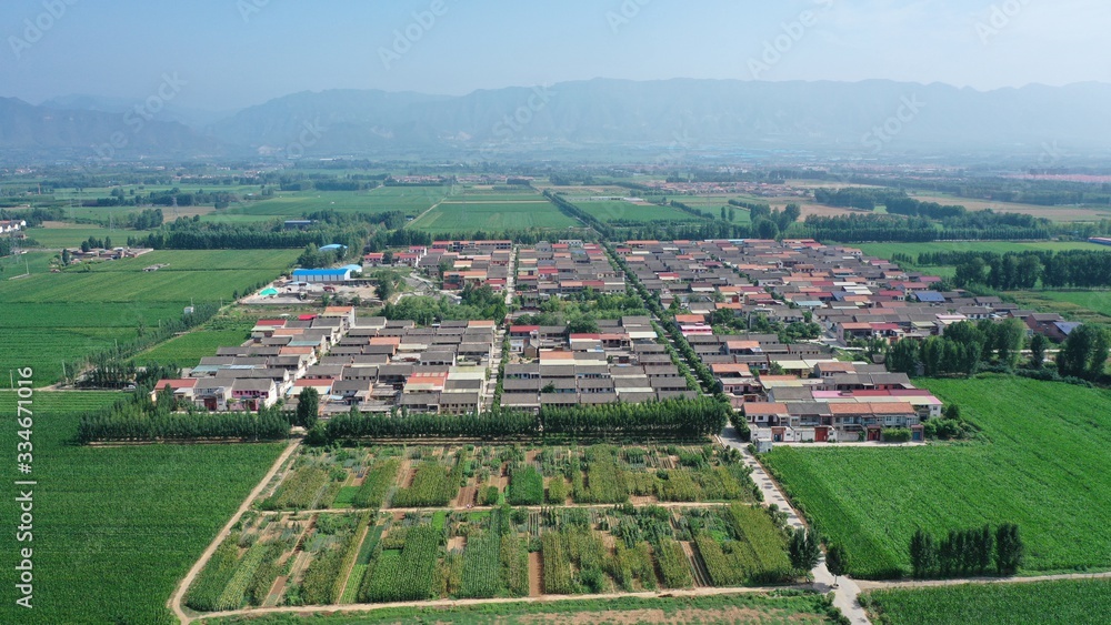 Panorama of rural landscape in China, village surrounded by green farmland