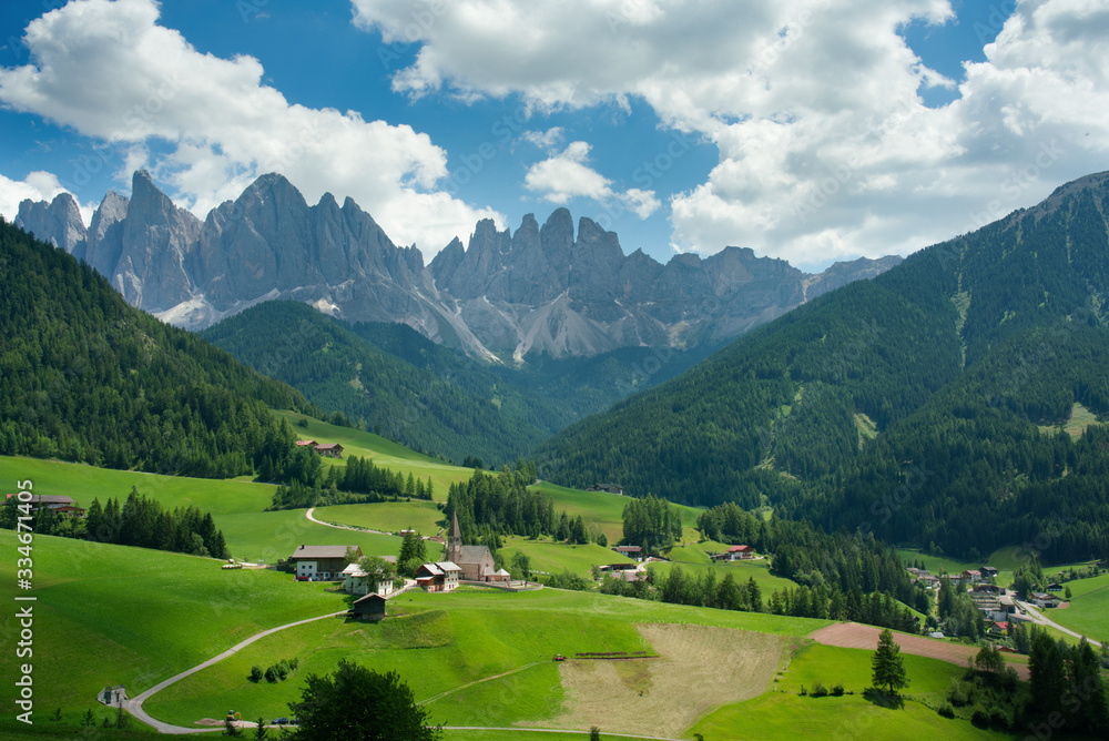 Amazing scenery of high mountains behind Santa Maddalena in summer; dolomites