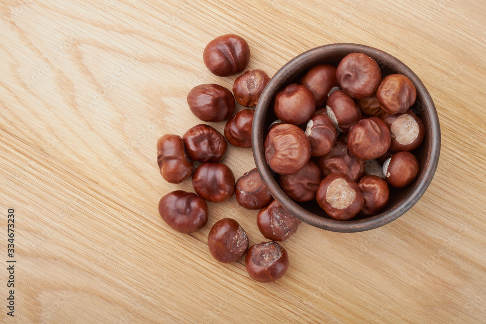 Chestnuts. Buckeye. Autumn mood. Sweet chestnuts on a wooden background. Chestnuts. Buckeye. Autumn mood. Sweet chestnuts on a wooden background.