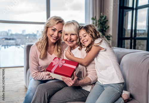 Women generation at home. Daughter, mother and grandmother spending time together. Celebrating Mother's Day photo