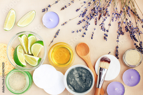 Natural ingredients in bowls top view for making facial clay mask with lavender herb and aromatic essential oil of lime for healthy skin care   beauty treatment.  Homemade spa cosmetic recipe