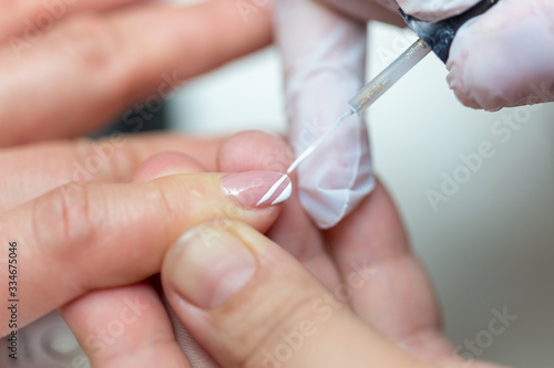 Close-up shot of a woman in manicure. Woman gets a manicure for nails