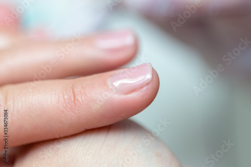 Close-up shot of a woman in manicure. Woman gets a manicure for nails