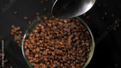 Pouring coffee from a spoon. Coffee beans. Coffee. The production of coffee. Close-up.