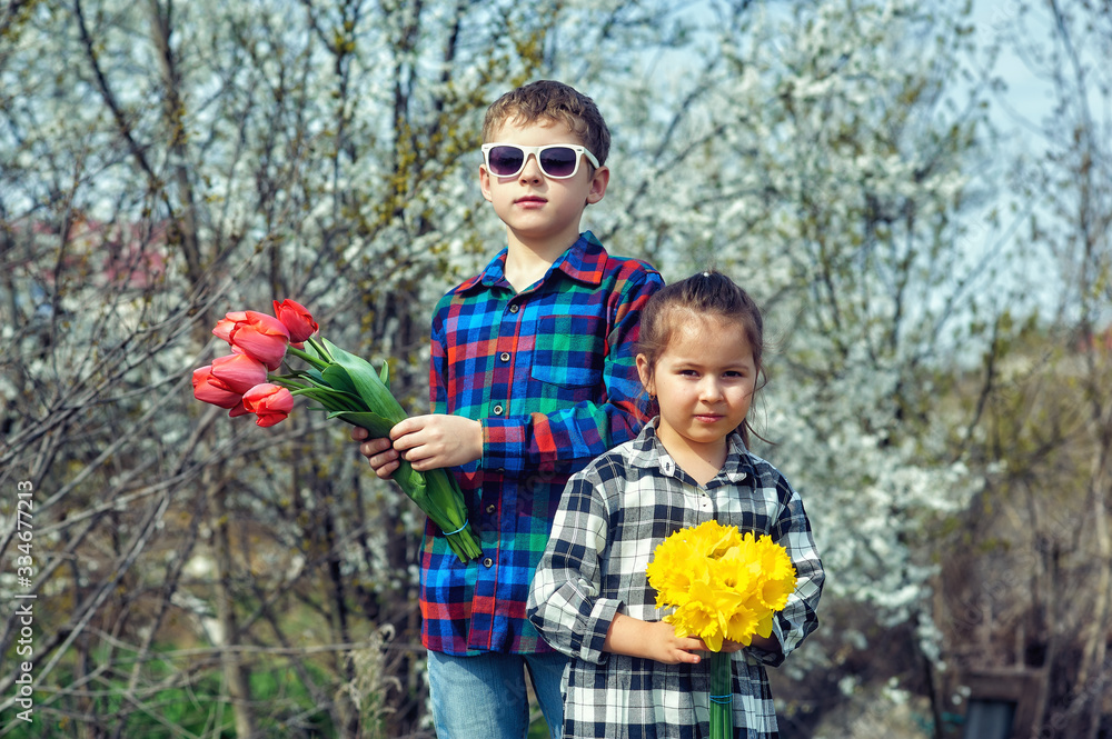 Children with a bouquet of flowers, brother and sister holding bouquets of flowers