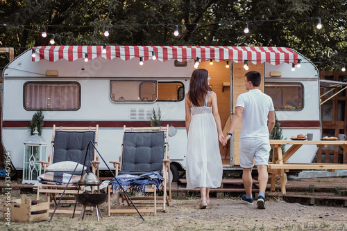 A young beautiful couple travels around the country together on a trailer.