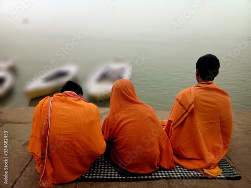 The children of Brahmin cast in India are performing their rituals at the ghats of Varanasi in India at the bank of river Ganges with selective focus. photo