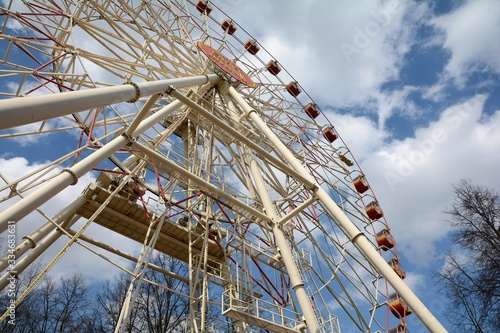 Fototapeta Naklejka Na Ścianę i Meble -  Ferris wheel in Minsk Gorky Park. Established in 2003. Height 54 meters. Number of seats: 144. 4 open booths and 32 closed. Children's attraction.
