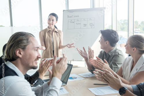 Attractive young asian business woman success explaning to her coworker team in meeting conference at modern office,Presentor female explain strategy plan to company partner with happy face and smile.