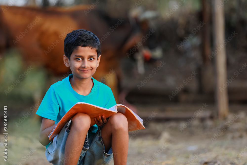 Cute indian child studying at home