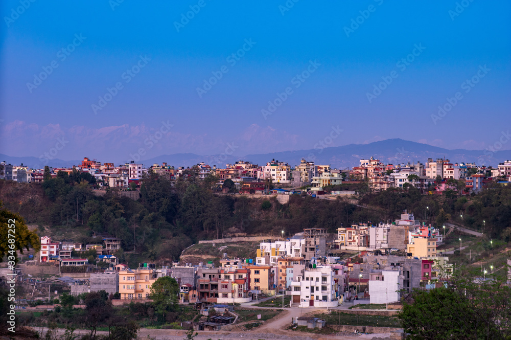 City Under the Evening Sunset and a Background of the Himalaya Mountain Range