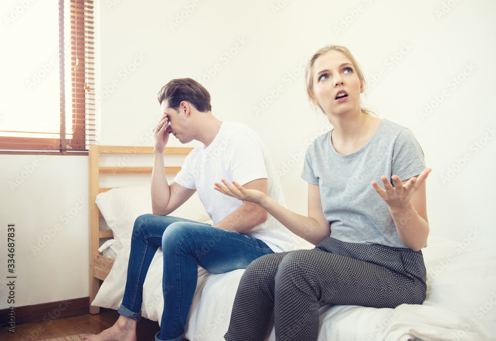 Unhappy young couple arguing, offended affronted woman ignoring angry man sitting her back to jealous husband shouting at frustrated wife, family fight at home, bad marriage relationships concept Unhappy young couple arguing, offended affronted woman ignoring angry man sitting her back to jealous husband shouting at frustrated wife, family fight at home, bad marriage relationships concept