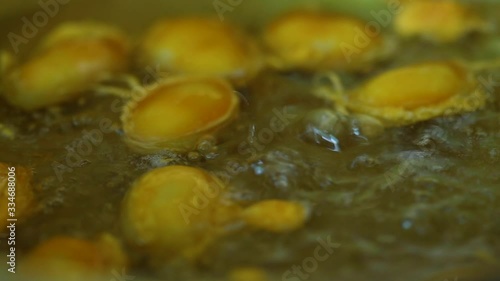 How to made thai dessert, close up fo Bean paste or Med Kanoon boiling in syrup in bronze pan.The most famous of Thai dessert.  photo