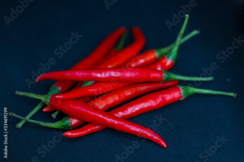 Red hot chili pepper isolated on black background.