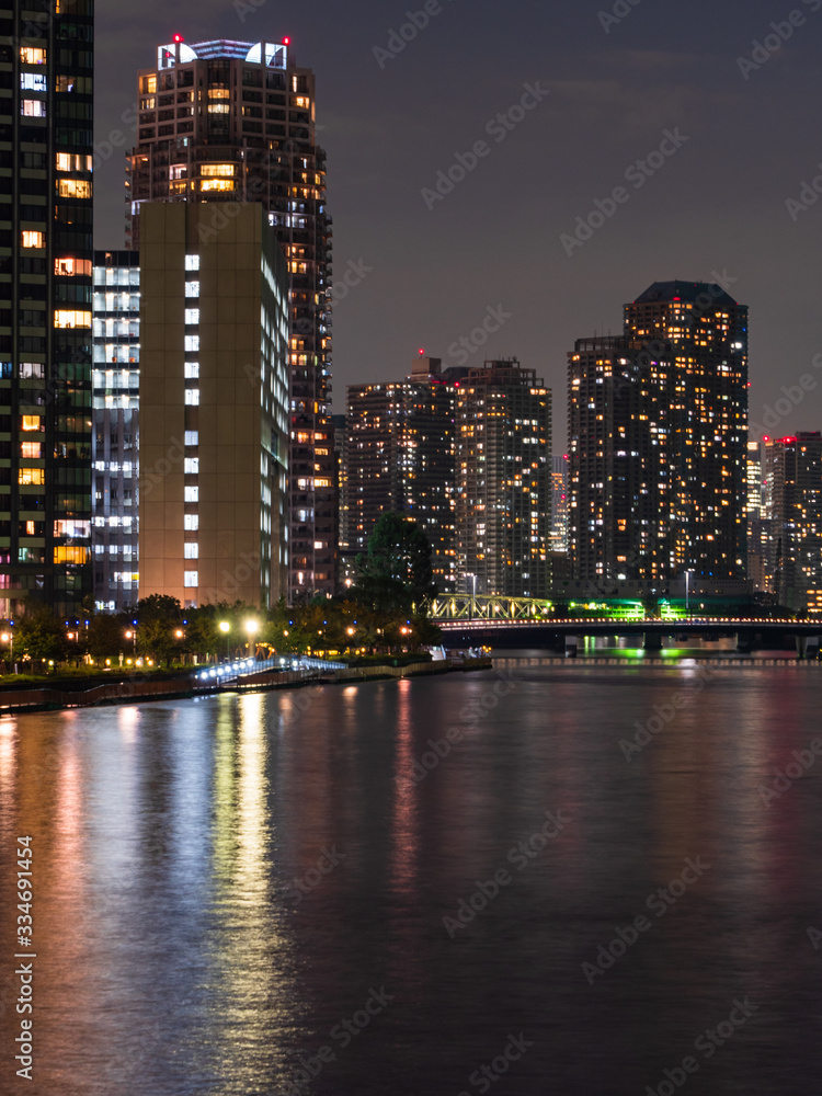 High rise buildings in Tokyo reflected in a river High rise buildings in Tokyo reflected in a river