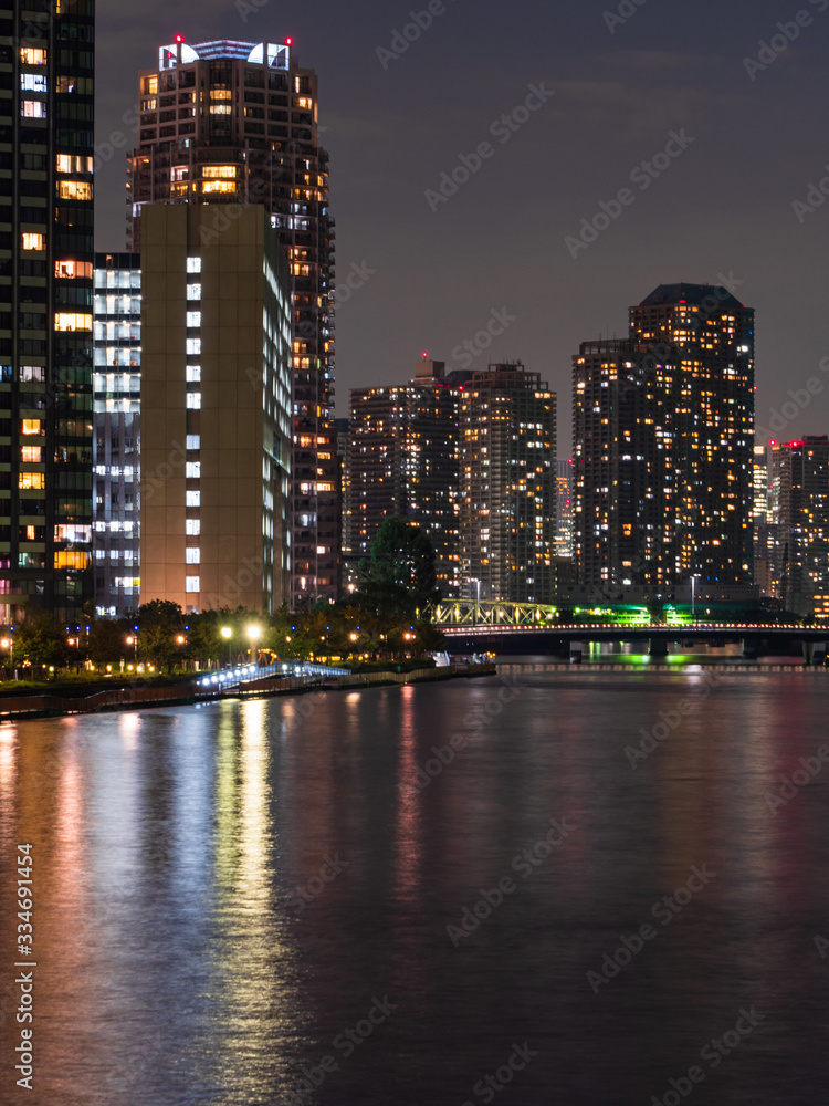 High rise buildings in Tokyo reflected in a river