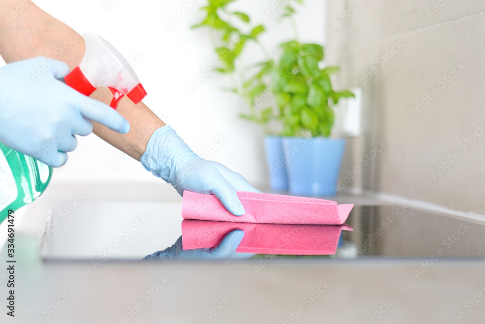 Woman in gloves cleaning kitchen.	 - obrazy, fototapety, plakaty 