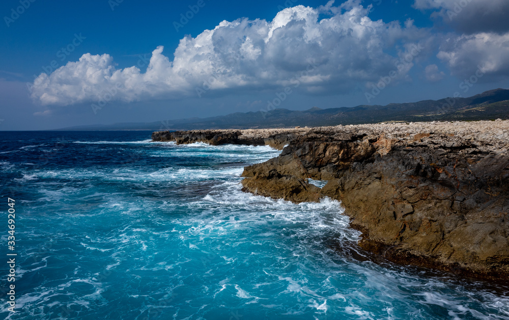 Waves crash on the rocky shore of the Mediterranean Sea on the Akamas Peninsula in the northwest of the island of Cyprus.