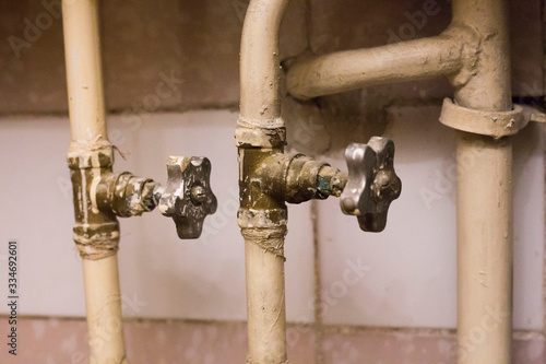 Fototapeta Naklejka Na Ścianę i Meble -  Old pipes with broken faucet valves.