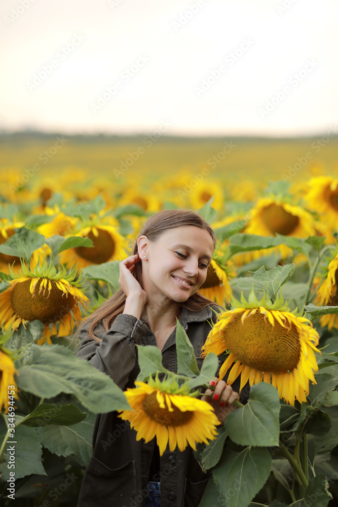 young beautiful woman on blooming sunflower field in summer, health and lifestyle young beautiful woman on blooming sunflower field in summer, health and lifestyle