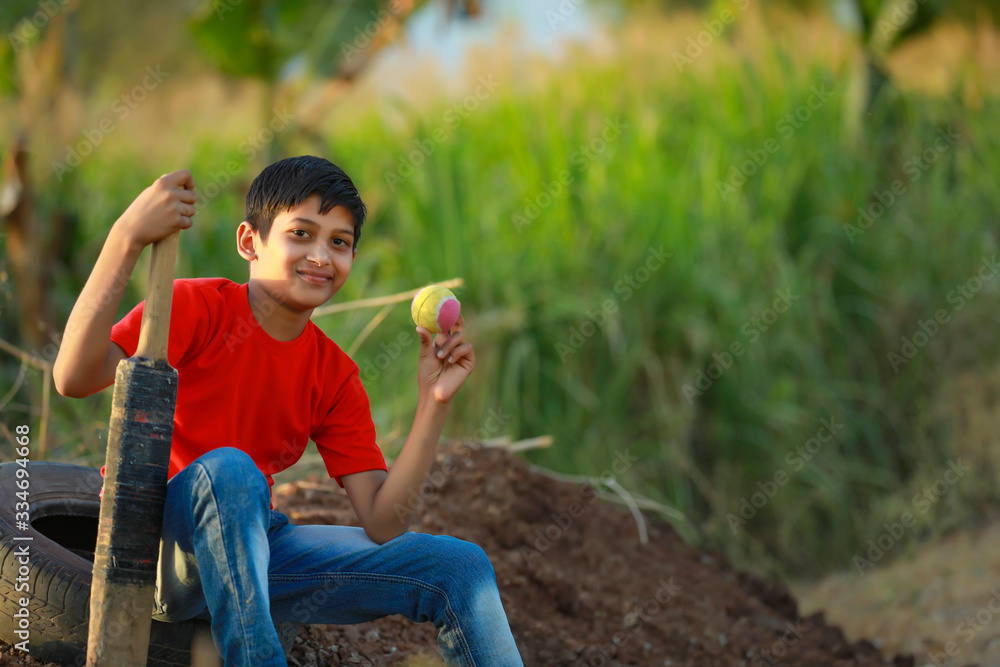 Fototapeta premium Rural Indian Child Playing Cricket
