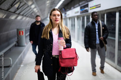 Young woman waiting for train in underground station