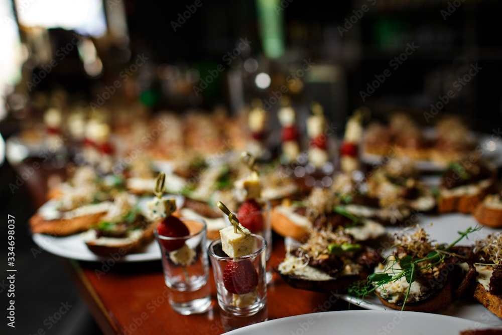 catering. canapes with cheese and strawberries on a skewer in a stack close-up on a buffet background