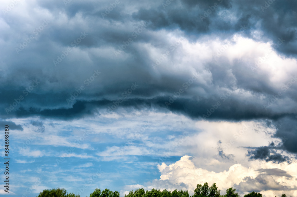 Gray white clouds. Clouds of thunderclouds on a blue sky. Summer day. Beautiful nature background Gray white clouds. Clouds of thunderclouds on a blue sky. Summer day. Beautiful nature background