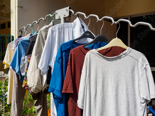Wet laundry / clothing hung outside on a clothes rack air dry on a sunny day