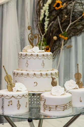 White wedding cake with golden decorations