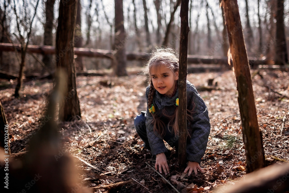 Young adventurers building a wooden habitat in the wild forest during social distant walking Young adventurers building a wooden habitat in the wild forest during social distant walking