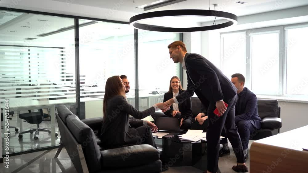 a businessman comes to a business meeting and greets colleagues a businessman comes to a business meeting and greets colleagues