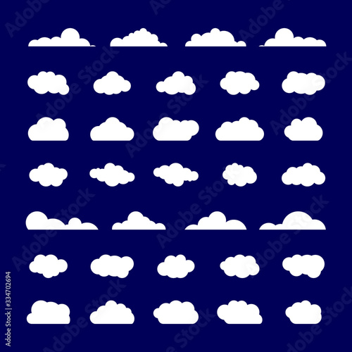 White Clouds. Set of white clouds of different shapes on dark blue background in the form of the sky. Flat. Vector illustration