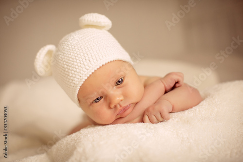 portrait of little girl in white bear hat. newborn
