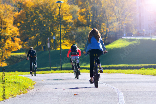 A group of cyclists moves along the autumn street of the city photo