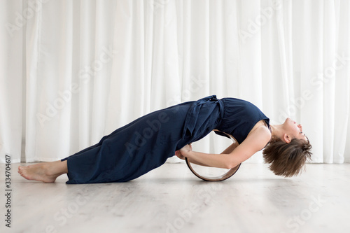 Woman is doing exercises with a yogo ring photo
