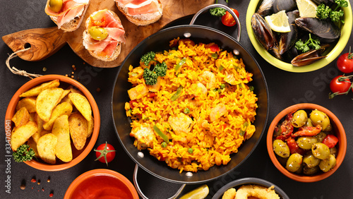assorted of spanish food- tapas, paella, potato bravas, mussels