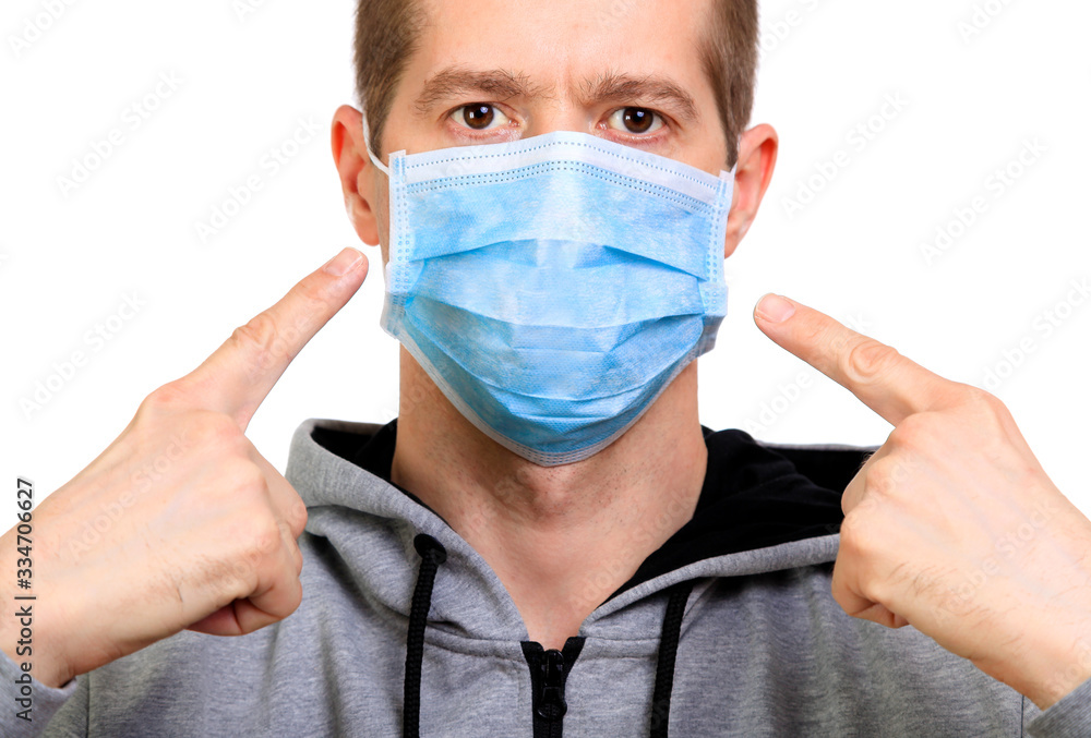 face of a man with a hood shows a medical mask, isolated, close-up face of a man with a hood shows a medical mask, isolated, close-up