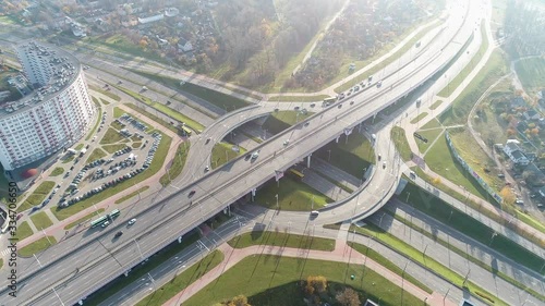 Road junction in European metropolis. High traffic. Cars drive along the road