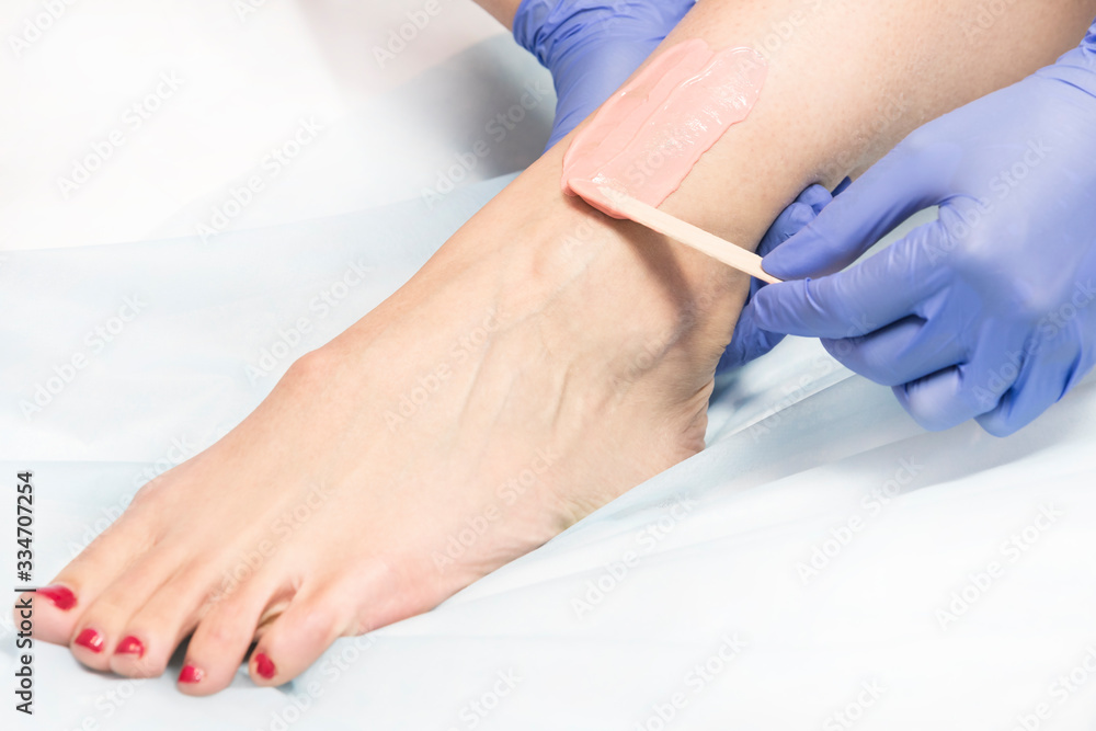The process of laser depilation of female limbs in the beauty salon. The process of laser depilation of female limbs in the beauty salon.