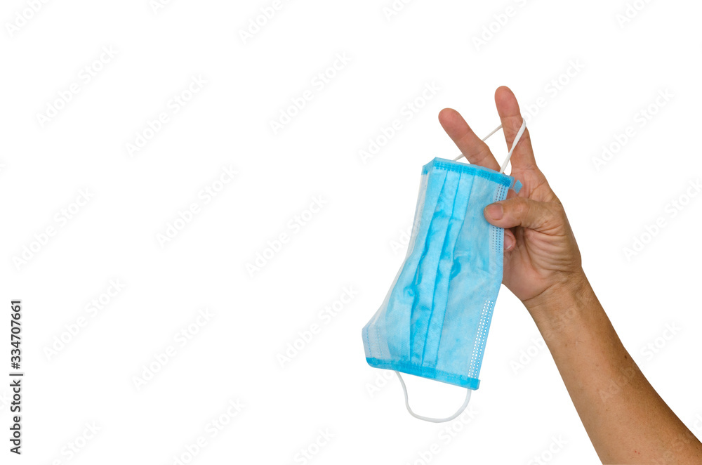 Holding a mask with two fingers on a white background Holding a mask with two fingers on a white background