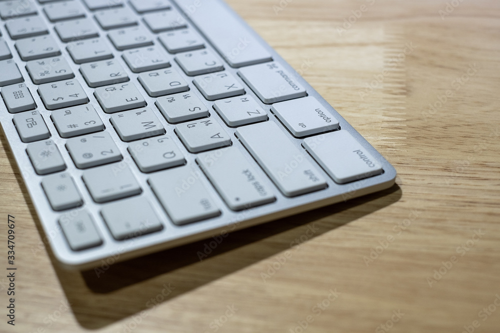 Modern computer keyboard on wooden table Modern computer keyboard on wooden table