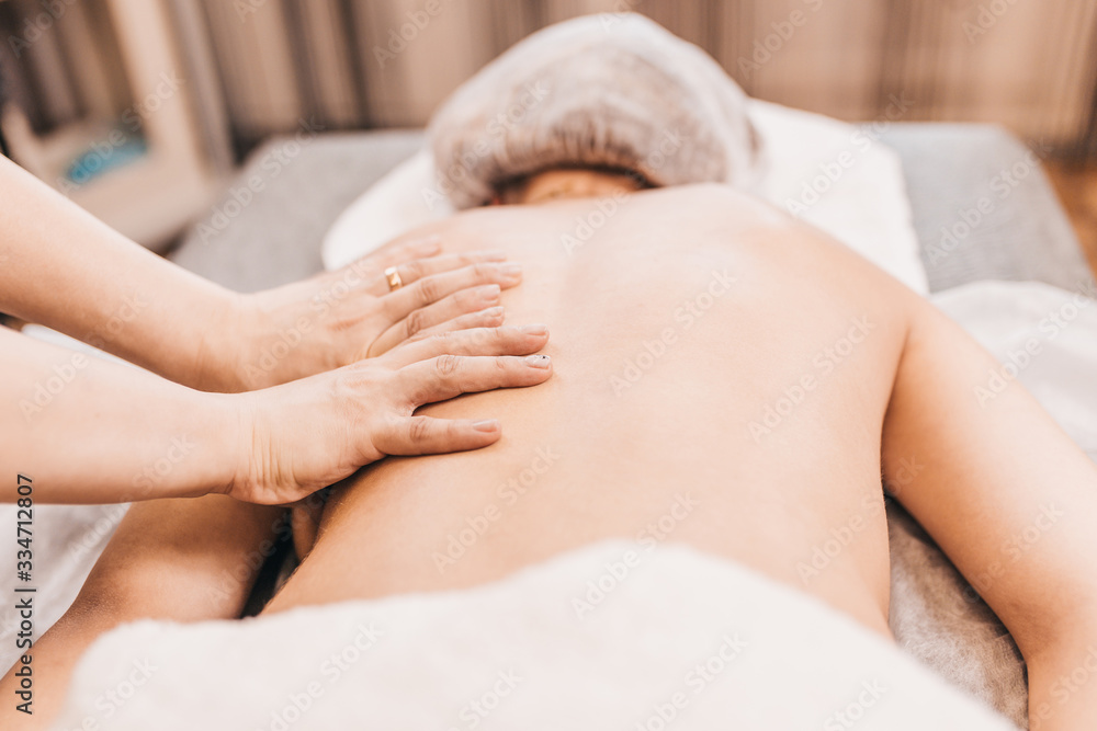 Back massage technique - close-up of a female masseur's hands Back massage technique - close-up of a female masseur's hands