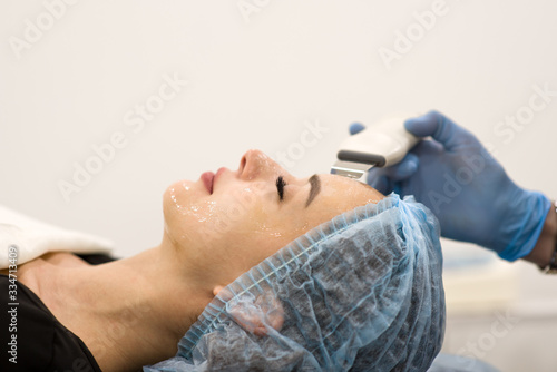 Face cleaning in a beauty salon - close-up of a woman's face