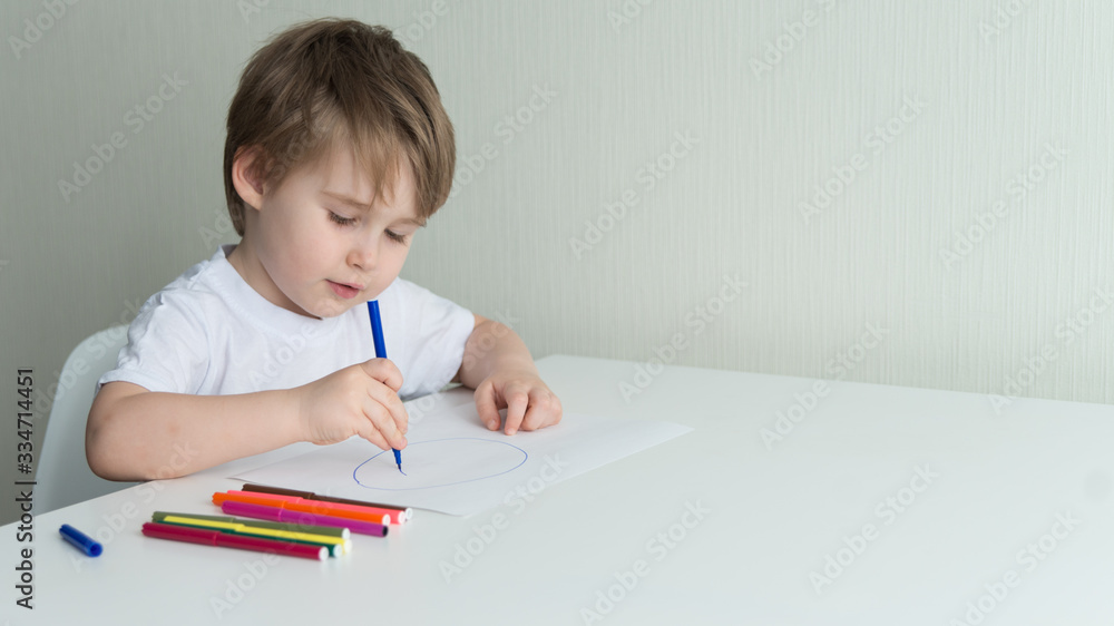 Little boy sitting on the chair and drawing Little boy sitting on the chair and drawing