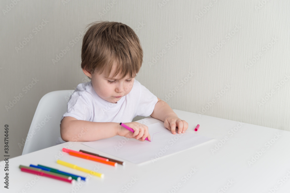 Little boy sitting on the chair and drawing Little boy sitting on the chair and drawing