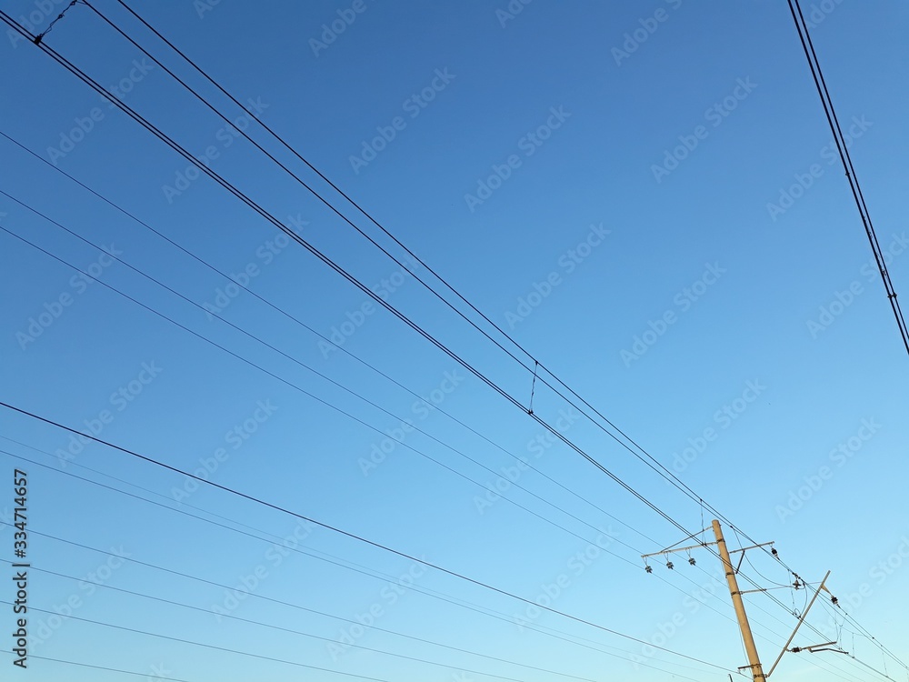 Electrical wires on blue sky background